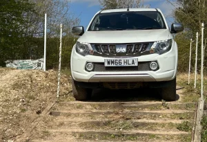 4x4 driver training Mitsubishi navigating controlled descent over wooden track steps near Market Rasen