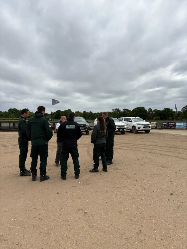 NHS London Ambulance Service HART team debriefing with Beyond Driving instructors at off-road training venue