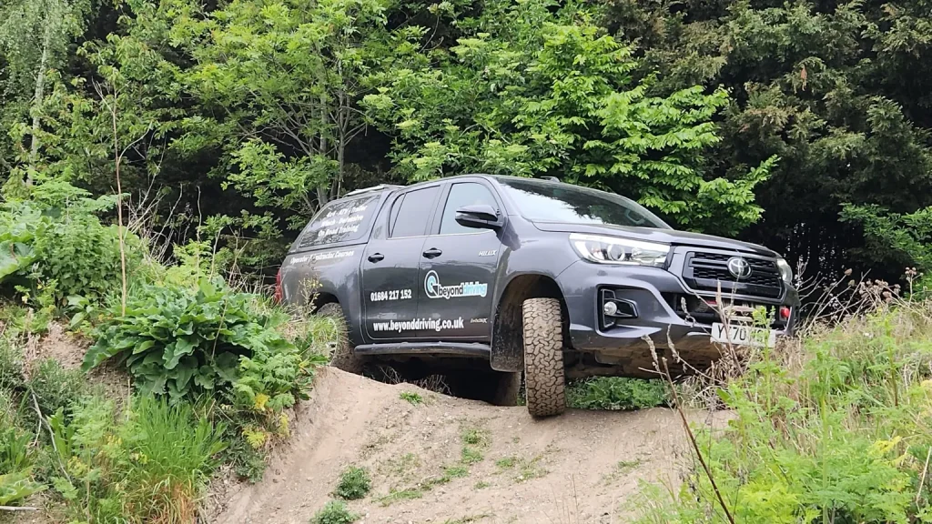 Toyota Hilux training vehicle tackling off-road terrain during Beyond Driving’s Lantra 4x4 course for NHS HART teams