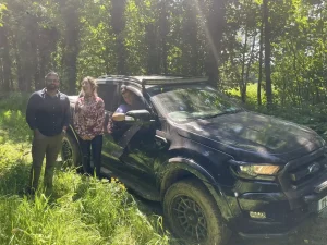 Participants posing beside muddy 4x4 vehicle after successful LANTRA operator training session in Ireland
