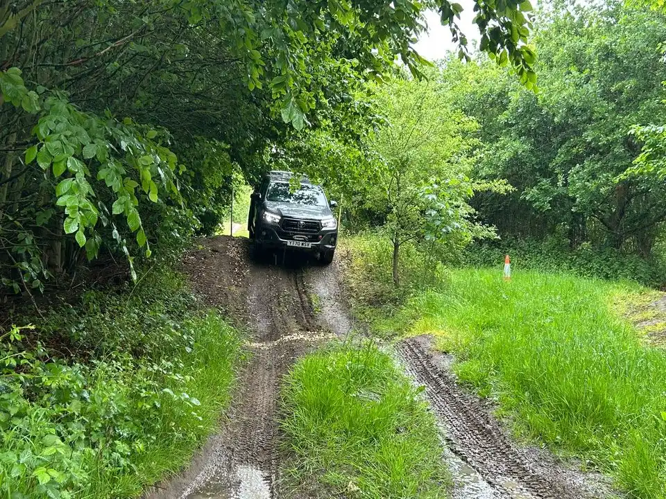 White Beyond Driving Toyota Hilux on muddy woodland track during LANTRA 4x4 training in Lincolnshire
