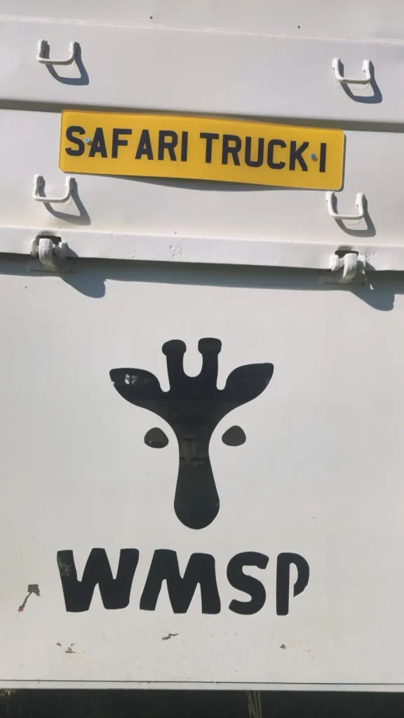 Close-up of WMSP Safari Truck logo with giraffe illustration