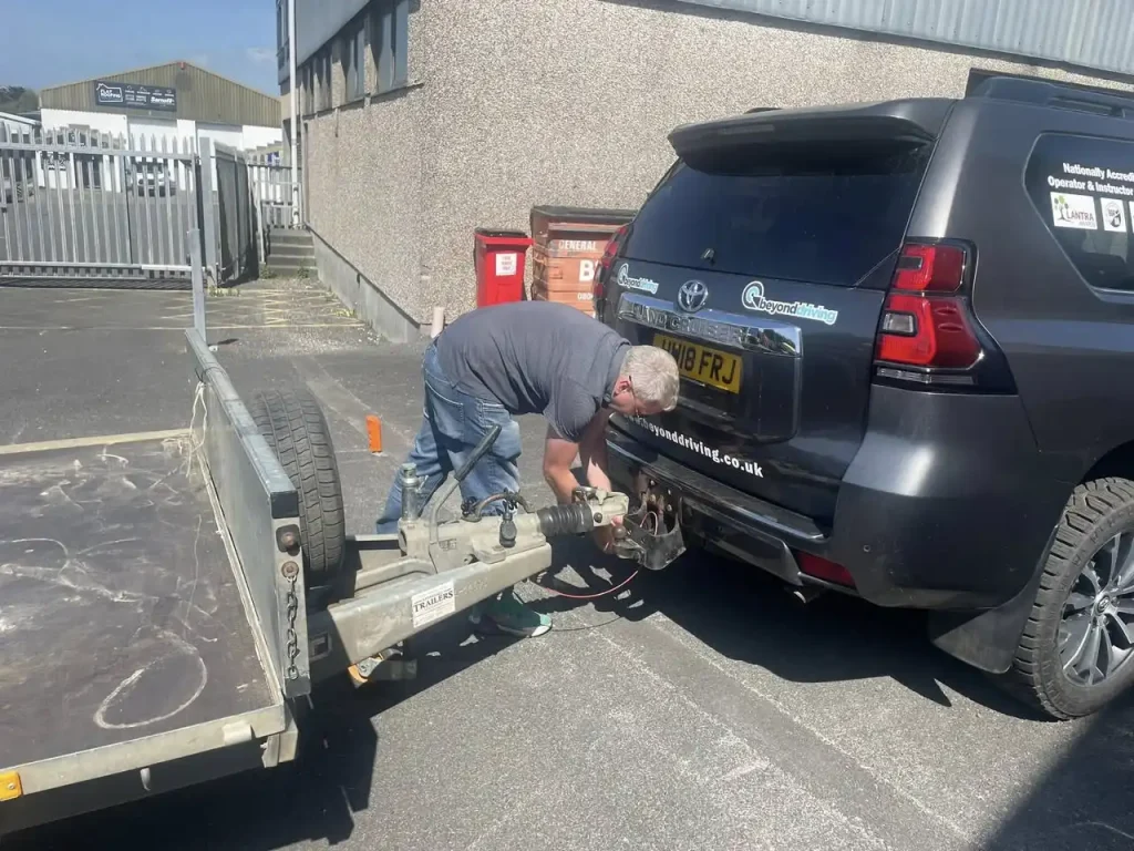 Instructor demonstrating safe trailer coupling during hands-on Lantra course with Beyond Driving