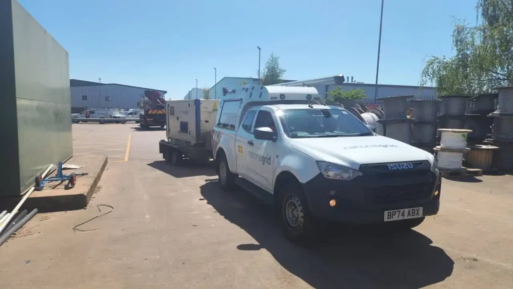 National Grid Isuzu utility vehicle towing a generator trailer during onsite trailer handling training
