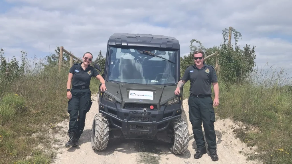 Two NHS HART team members standing beside a Polaris UTV during Lantra operator training with Beyond Driving near Andover