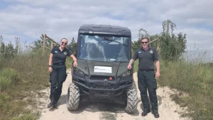 Two NHS HART team members standing beside a Polaris UTV during Lantra operator training with Beyond Driving near Andover