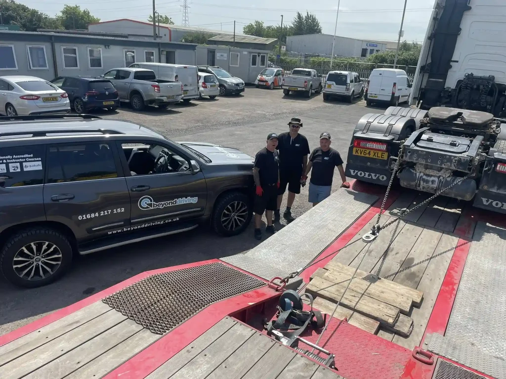 Beyond Driving instructors delivering Lantra Winch Operator Training to RC Express team in Avonmouth beside Volvo low-loader truck