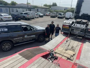 Beyond Driving instructors delivering Lantra Winch Operator Training to RC Express team in Avonmouth beside Volvo low-loader truck