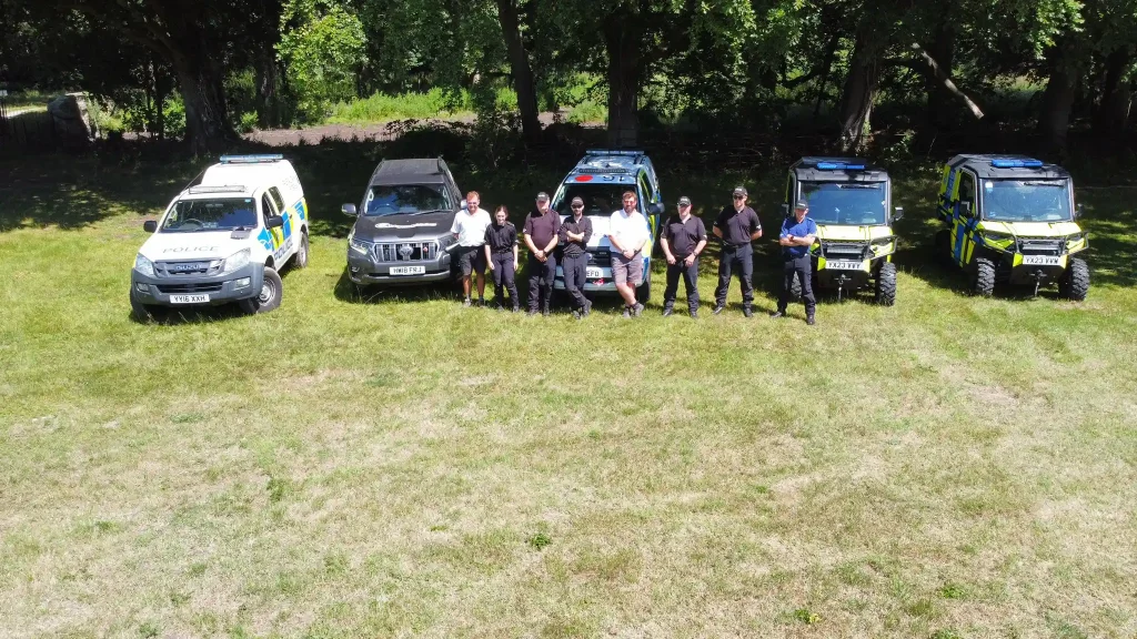 Aerial view of police officers and off-road vehicles including Polaris Rangers during UTV training session