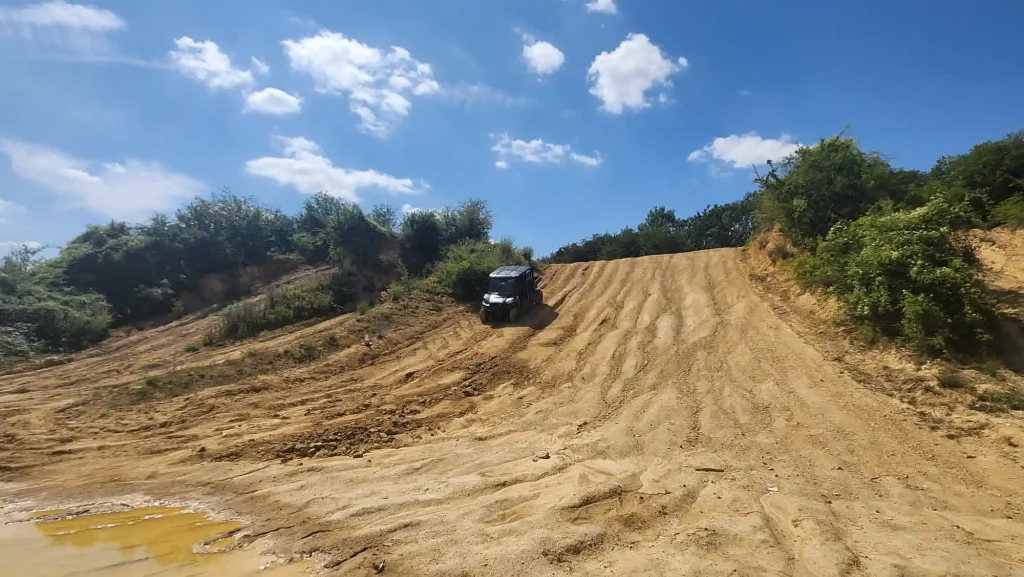 UTV tackling a steep sandy incline during off-road driver training with Beyond Driving near Peterborough