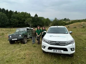 Worcestershire Wildlife Trust team with Beyond Driving trainer and training vehicles near Pershore, West Midlands