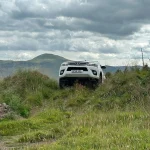 524731689_1239439241312857_2213060599044980547_n Toyota Hilux 4x4 ascending a grassy incline during off-road driver training in Fife with Beyond Driving