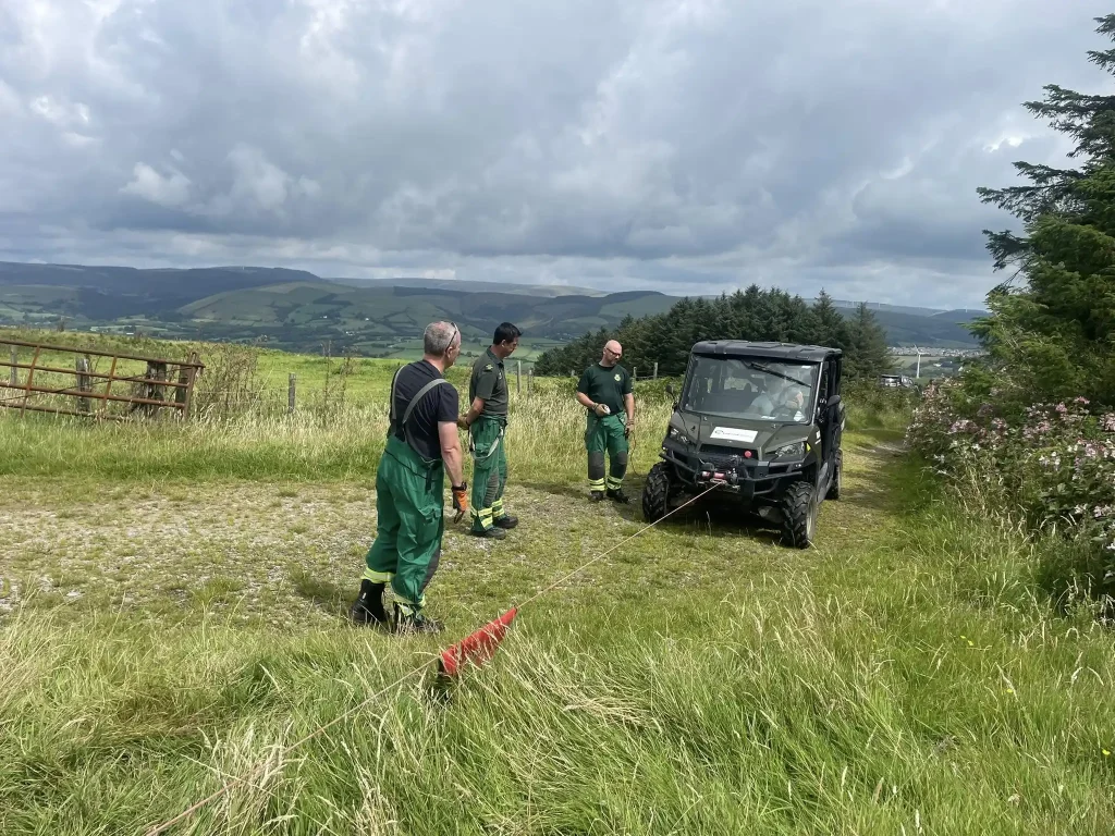 Hands-on winch instruction beside Polaris UTV during Beyond Driving training with Welsh HART in Bridgend