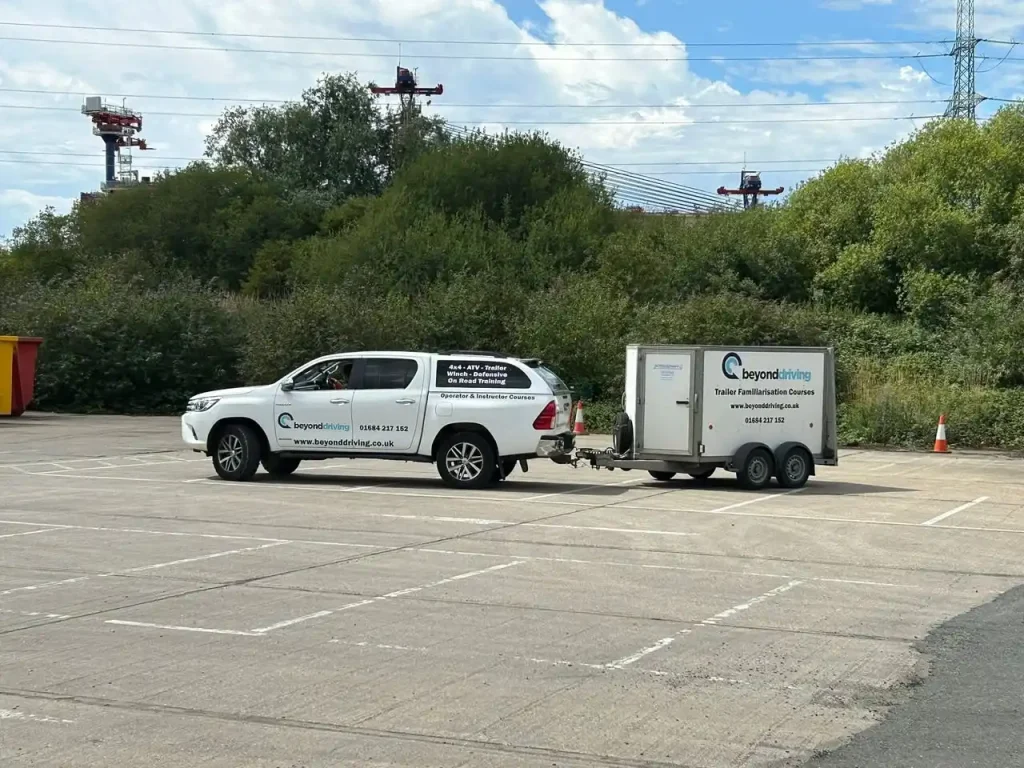 Beyond Driving vehicle practising trailer reversing techniques in open training area