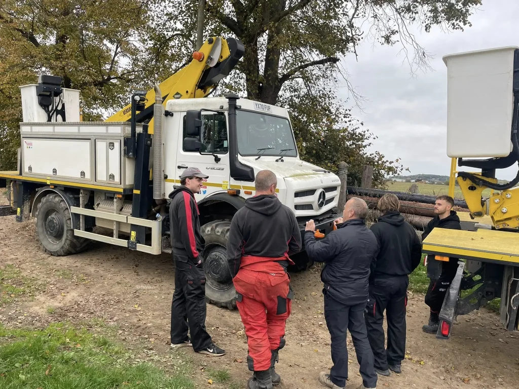 Beyond Driving instructor briefing Northern Powergrid drivers beside Unimog vehicles during 4x4 training near Leeds.