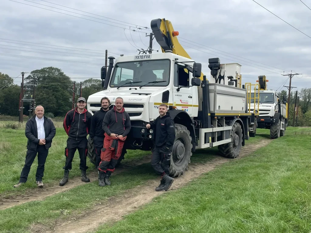 Northern Powergrid team standing beside Unimog vehicles after completing Beyond Driving 4x4 driver training.