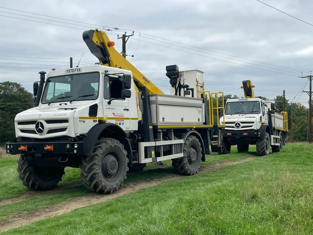Two Unimog 4x4 vehicles lined up for off road driver training with Beyond Driving.