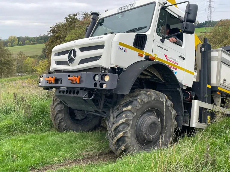 Mercedes-Benz Unimog tackling an off road slope during Beyond Driving bespoke training.
