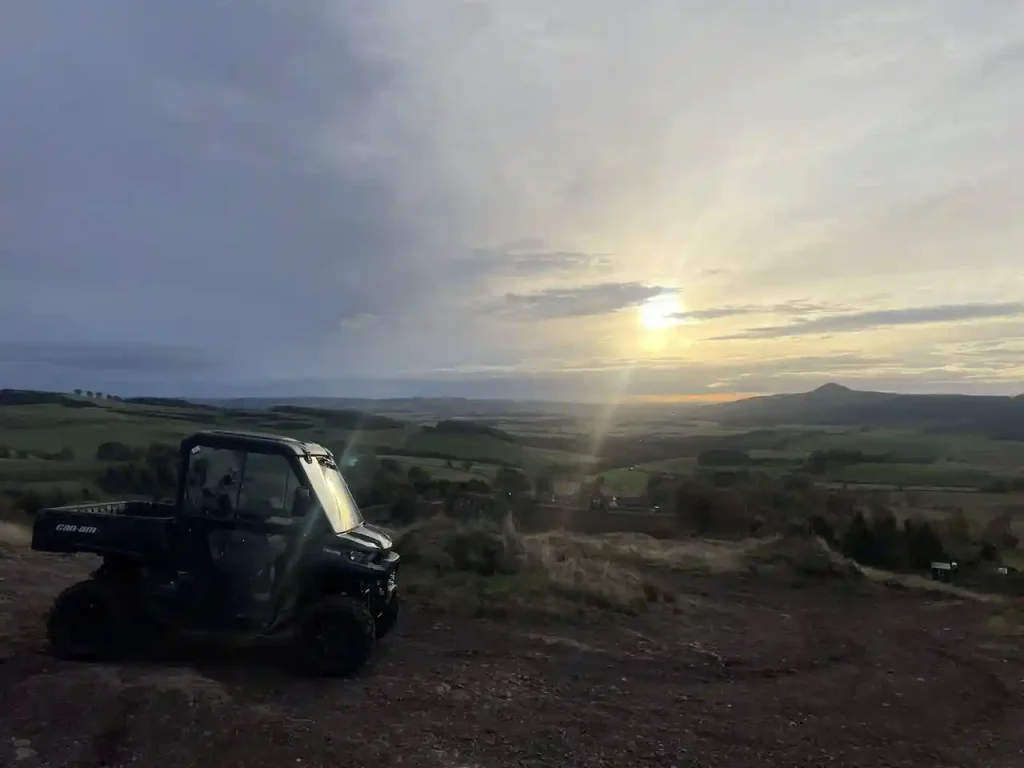 Beyond Driving instructors with Can-Am UTV at Lantra training site near Glenrothes, Fife with Scottish Highlands landscape in background
