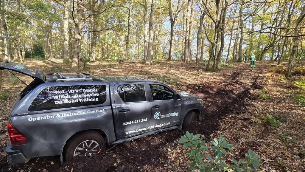 Beyond Driving 4x4 instructor training in woodland terrain showing vehicle control in challenging conditions