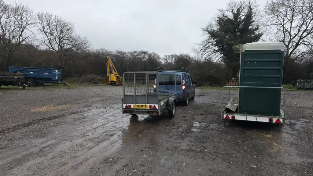 RSPB operator towing utility trailer across rural site during Lantra trailer handling training in Dorset