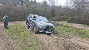 Toyota Hilux navigating muddy terrain as part of Qualsafe Level 4 instructor training for emergency services