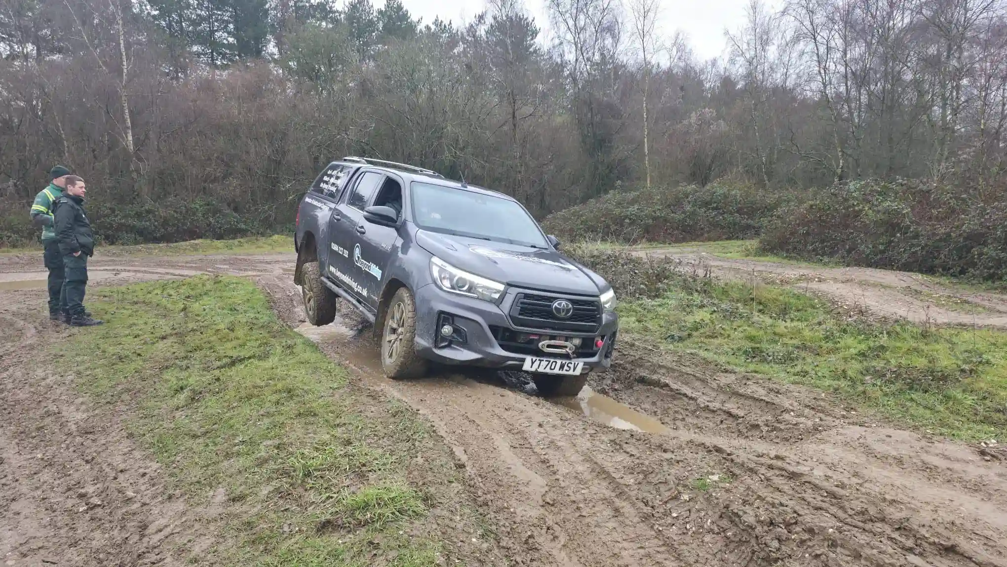 Toyota Hilux navigating muddy terrain as part of Qualsafe Level 4 instructor training for emergency services