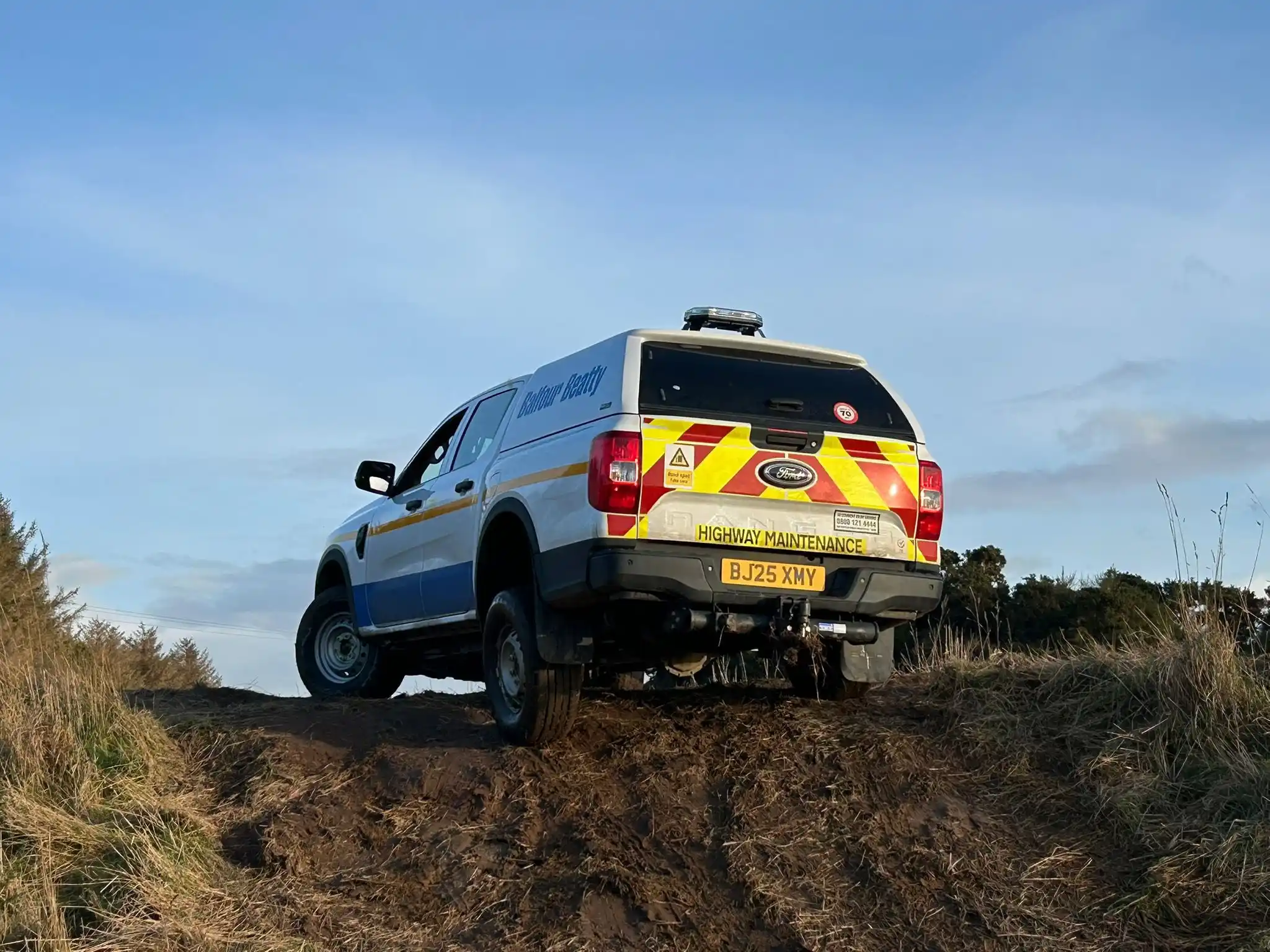 Balfour Beatty vehicle completing Lantra 4x4 operator training on uneven off-road terrain near Lossiemouth, Scotland