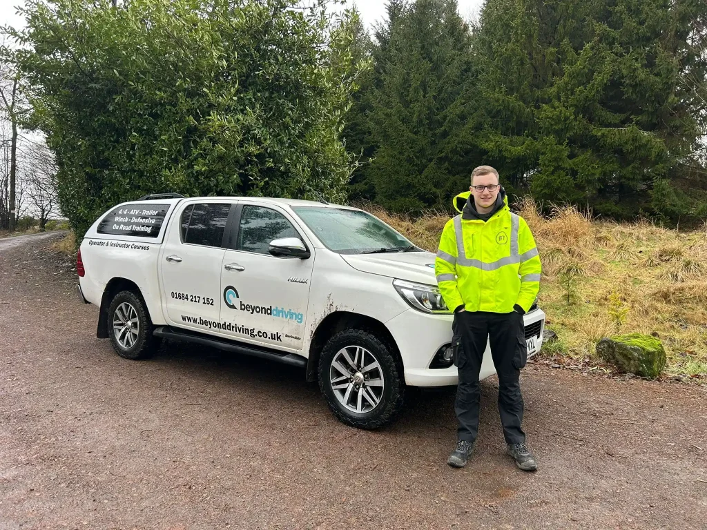 BT Openreach trainee standing beside a Beyond Driving vehicle during Lantra 4x4 training in Scotland