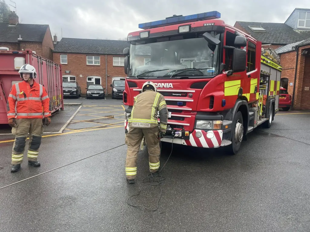 Firefighter conducting front-mounted winch setup during Qualsafe accredited winch instructor training with Beyond Driving