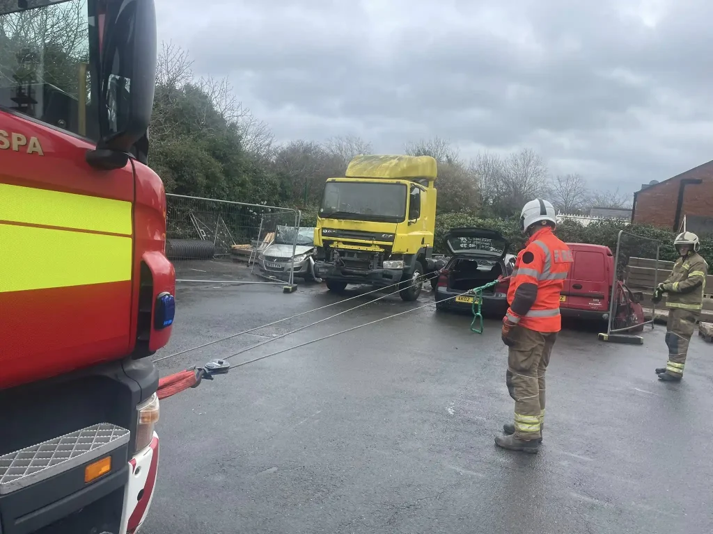 Fire service trainees managing tensioned winch lines during practical vehicle recovery instructor training