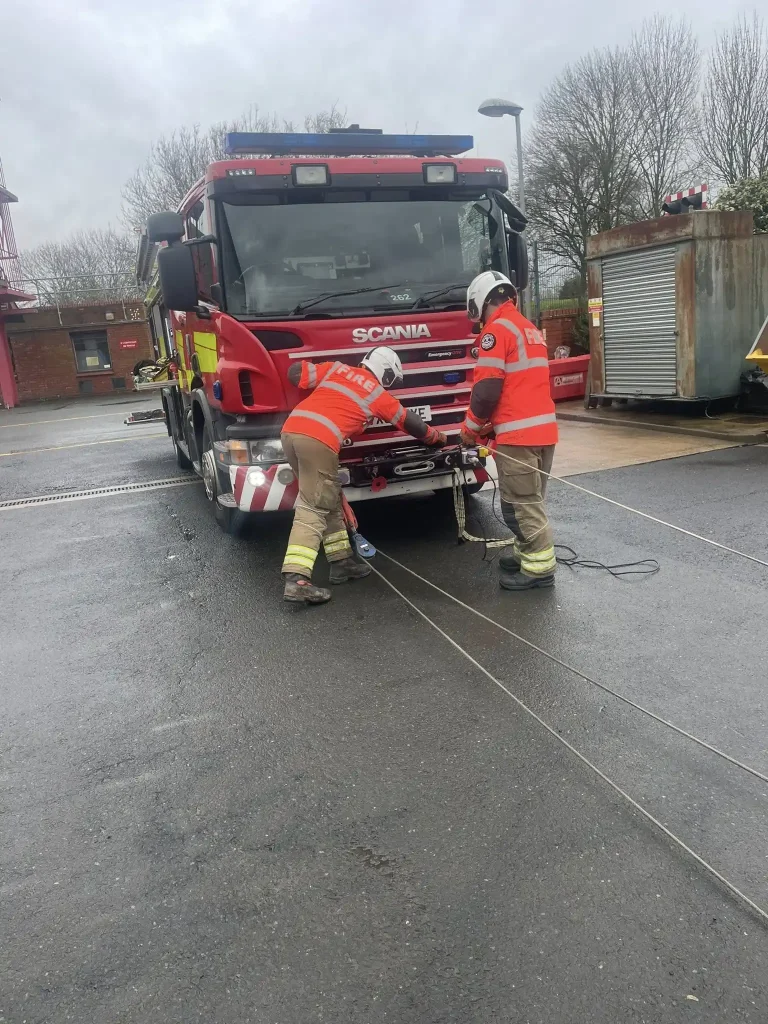 Firefighters operating Scania appliance winch under supervision during Qualsafe winch instructor training with Beyond Driving