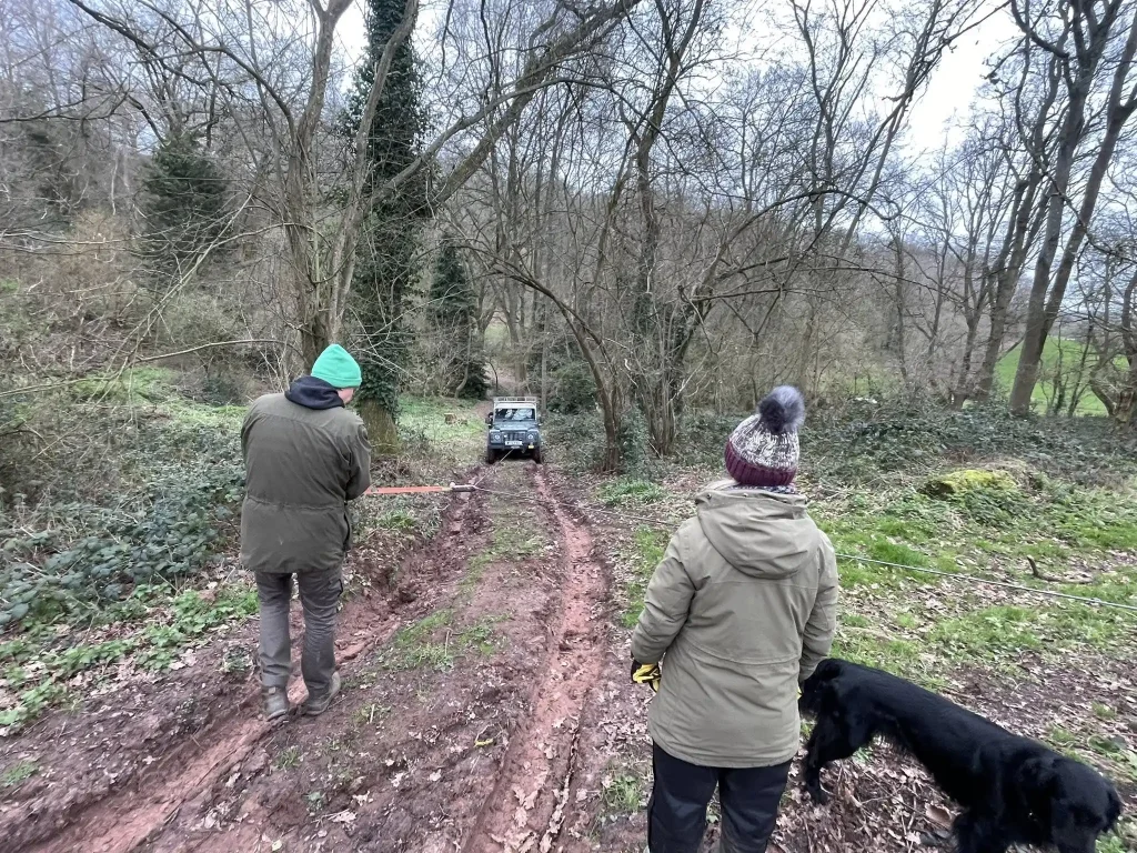 Lantra winch training in woodland terrain with 4x4 recovery on muddy track near Kidderminster