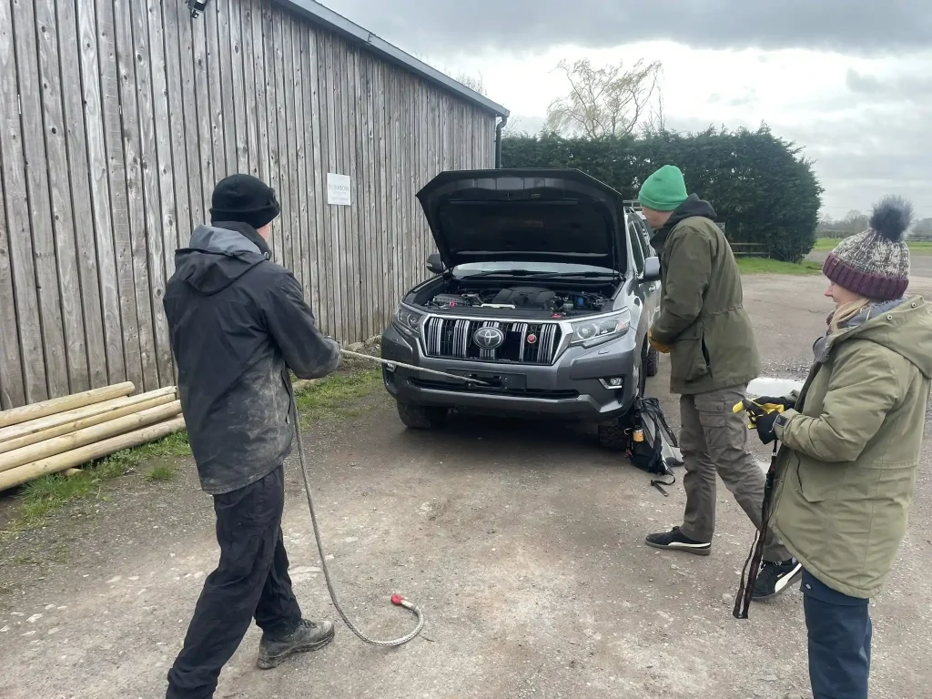 Participants preparing winch equipment and inspecting recovery gear during Lantra training course