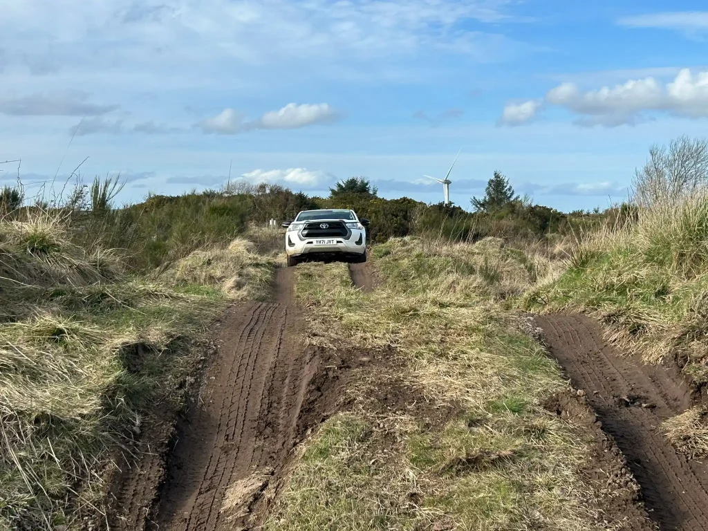 4x4 vehicle navigating deep ruts during Lantra off road driver training in Scotland