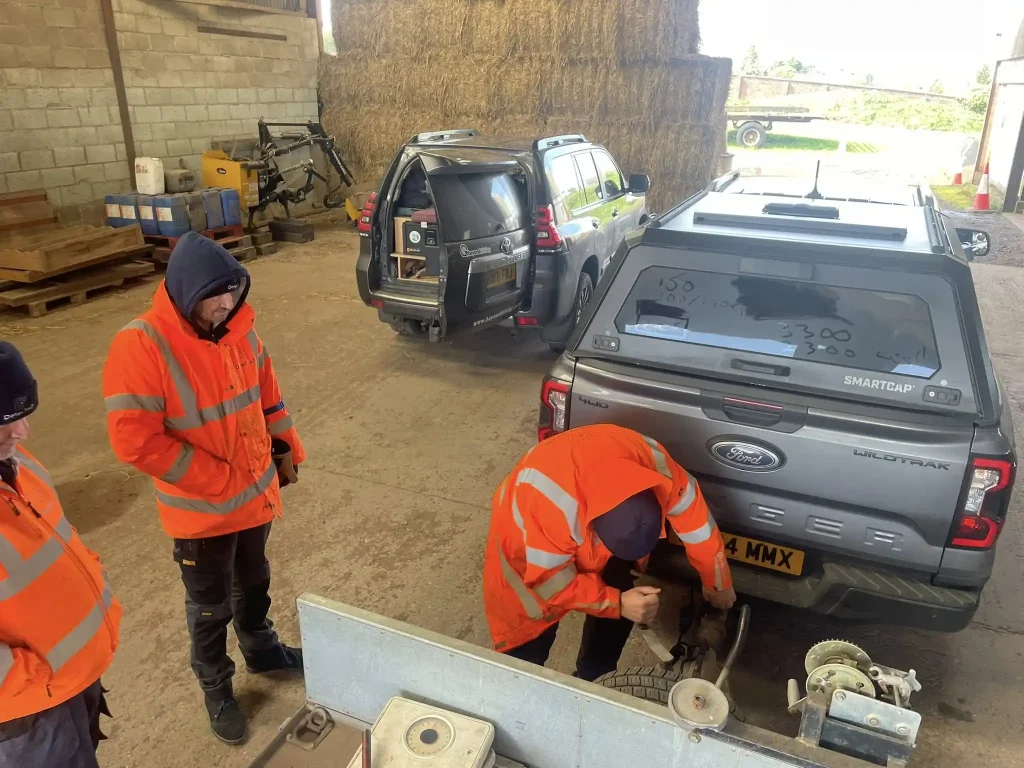 Trailer coupling demonstration inside agricultural building