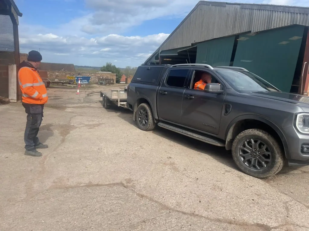 Ford pickup towing flatbed trailer reversing exercise
