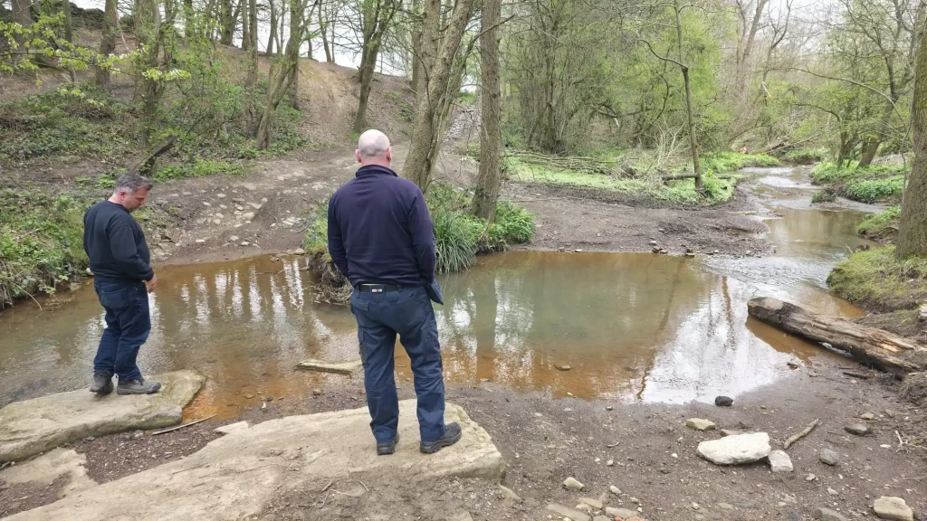Candidates assessing water crossing during 4x4 driver training course Yorkshire