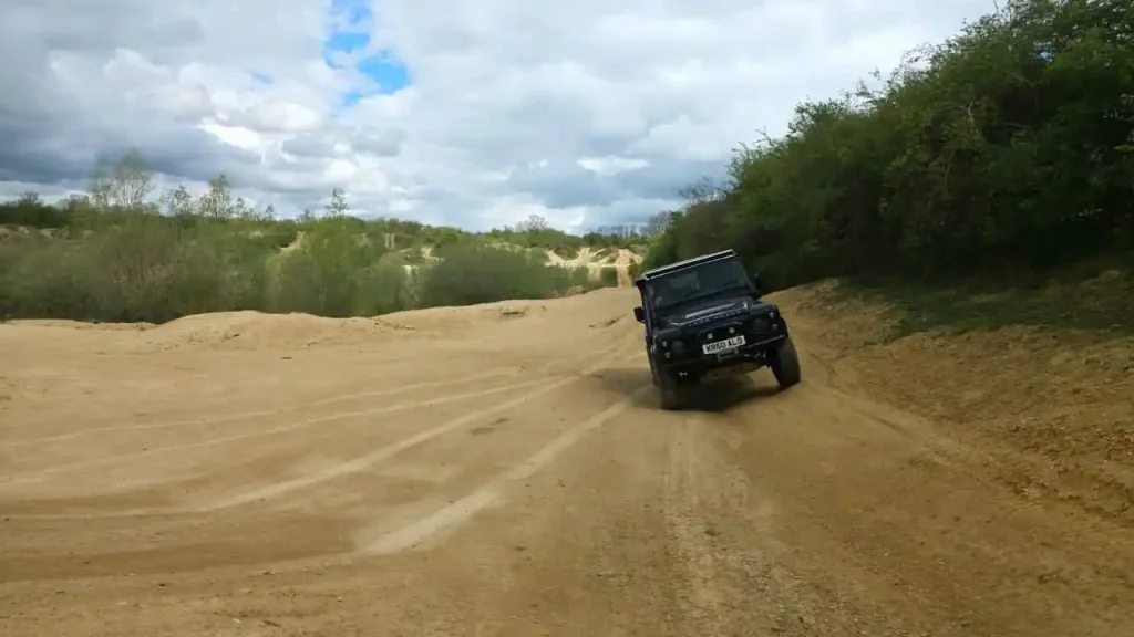 4x4 vehicle navigating side slope on sand terrain East Midlands training course