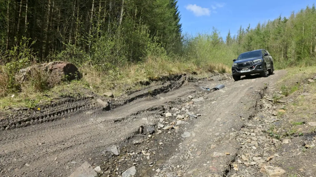     Off road driver training near Neath with 4x4 vehicle negotiating rocky rutted woodland terrain