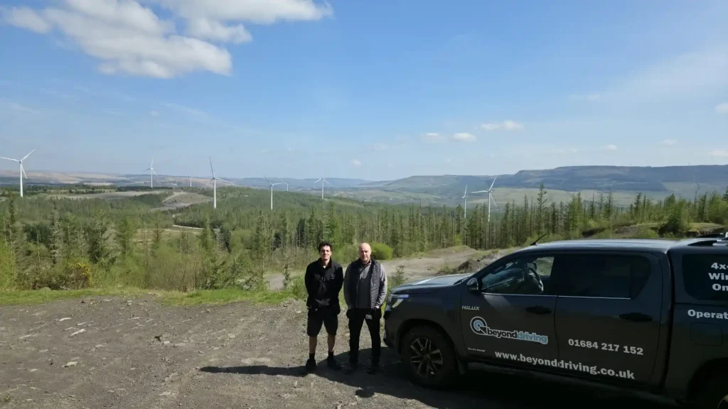     Beyond Driving off road driver training near Neath with 4x4 vehicle overlooking South Wales countryside and wind turbines