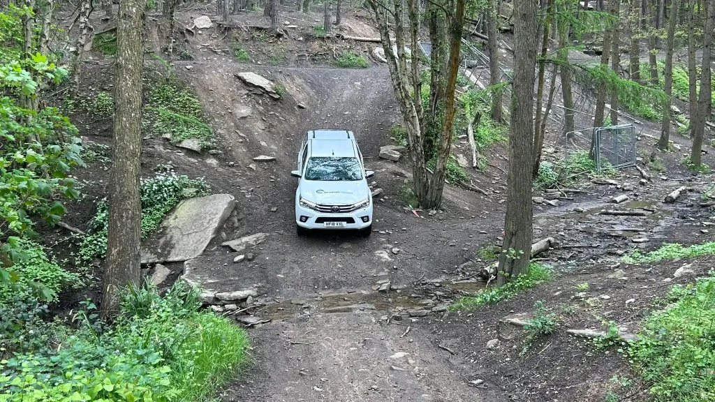 Beyond Driving 4x4 training vehicle on muddy woodland track near Bradford in West Yorkshire