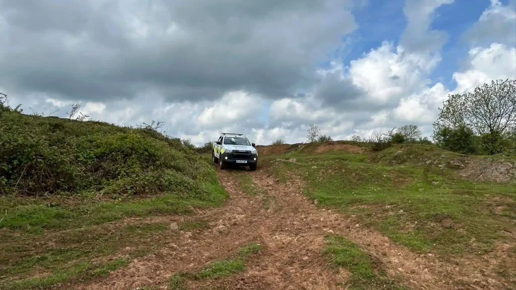 Beyond Driving 4x4 operator training vehicle descending an off-road track near Cheddar