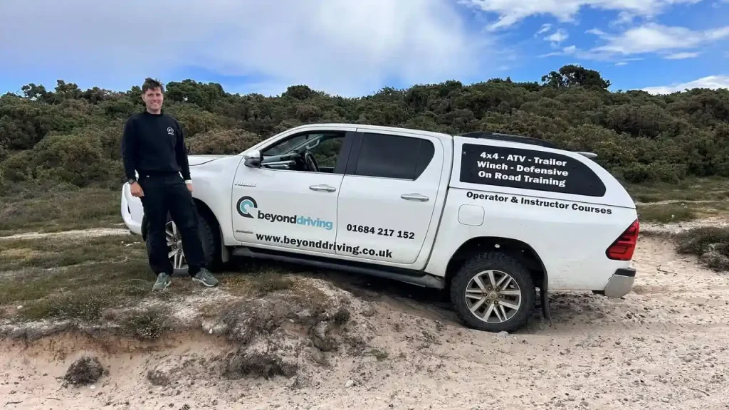 Toyota Hilux crossing soft sand during coastal 4x4 training