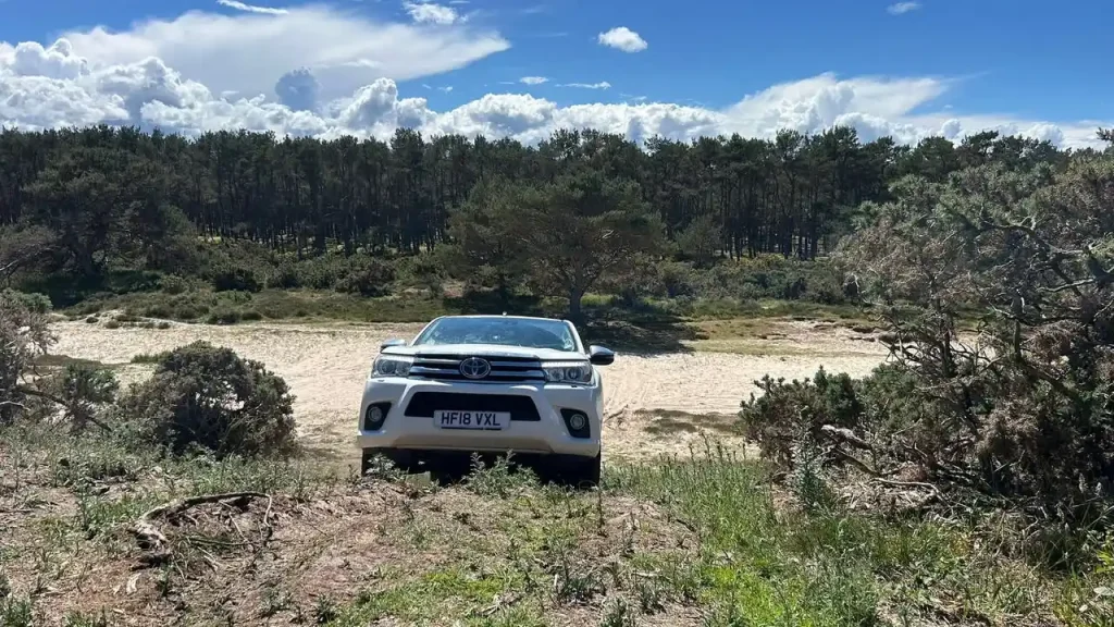 BT 4x4 operator training on coastal terrain with dunes in the background