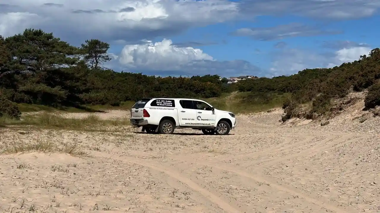 Beyond Driving 4x4 vehicle on sandy coastal training ground near Lossiemouth