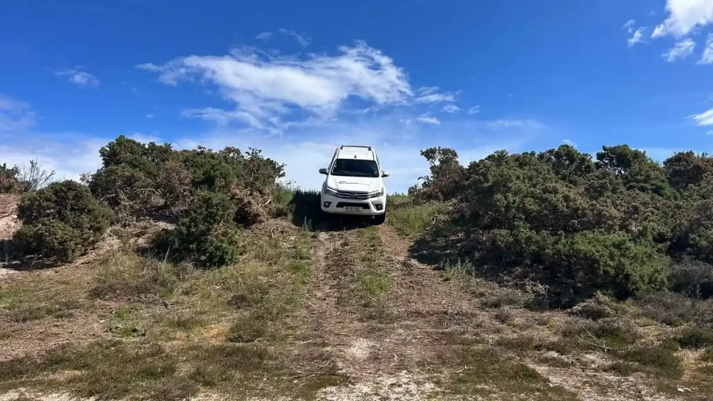 4x4 operator training on uneven coastal track in northern Scotland