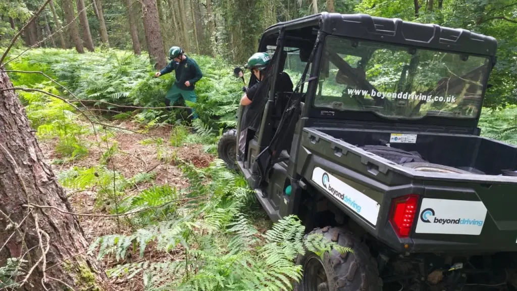 Polaris UTV negotiating uneven woodland ground during NHS HART off-road vehicle training