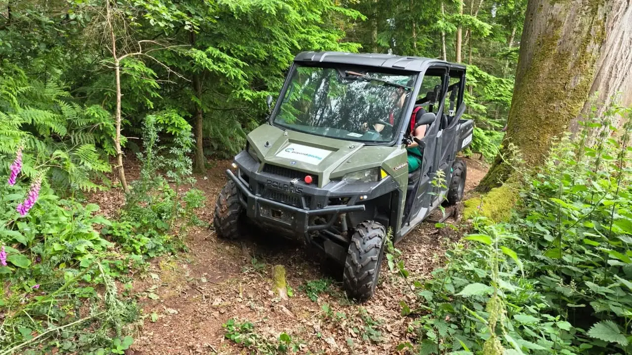 Polaris UTV negotiating uneven woodland ground during NHS HART off-road vehicle training