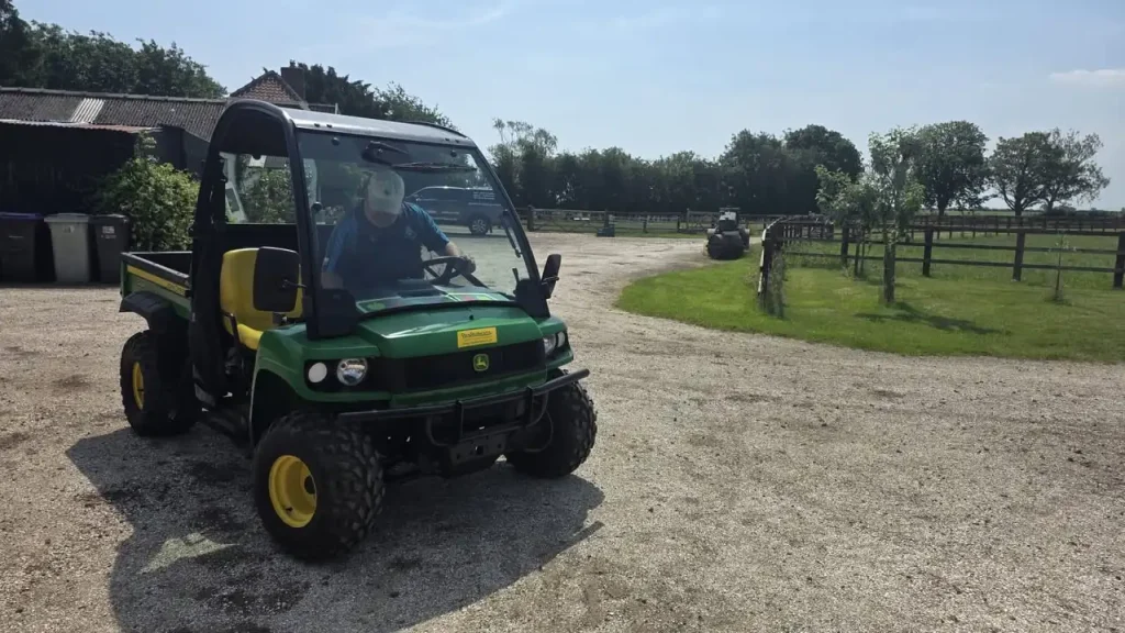 UTV operator training with a John Deere Gator on a farm track